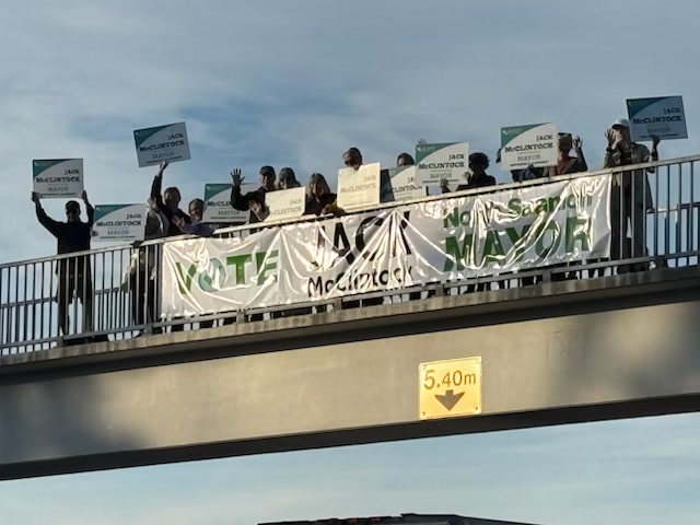 Jack McClintock campaign supporters holding signs on the Mt. Newton pedestrian overpass